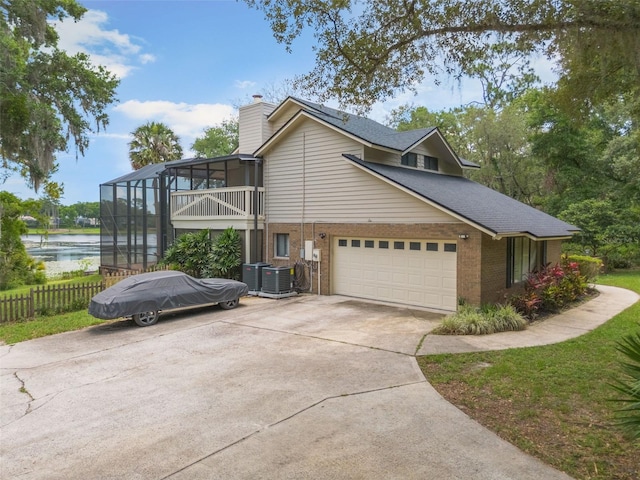 120 E Greentree Ln, Lake Mary, FL 32746 - view of property exterior featuring brick siding, a chimney, a water view, driveway, and a lanai