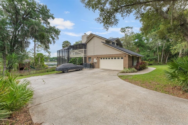 120 E Greentree Ln, Lake Mary, FL 32746 - view of home's exterior with driveway, brick siding, a chimney, a lanai, and a garage