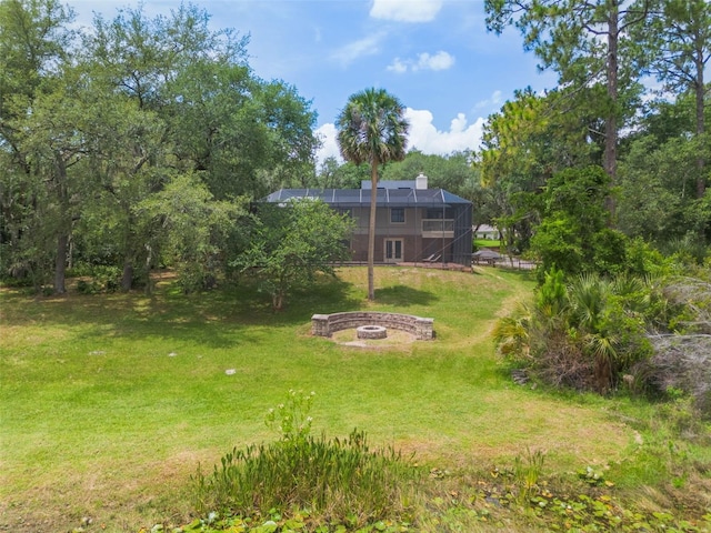 120 E Greentree Ln, Lake Mary, FL 32746 - view of green lawn with an outdoor fire pit and a lanai