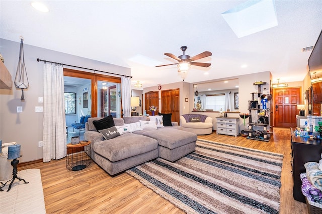 493 Princewood Dr, Deland, FL 32724 - living room with light wood finished floors, a skylight, healthy amount of natural light, ceiling fan, and recessed lighting