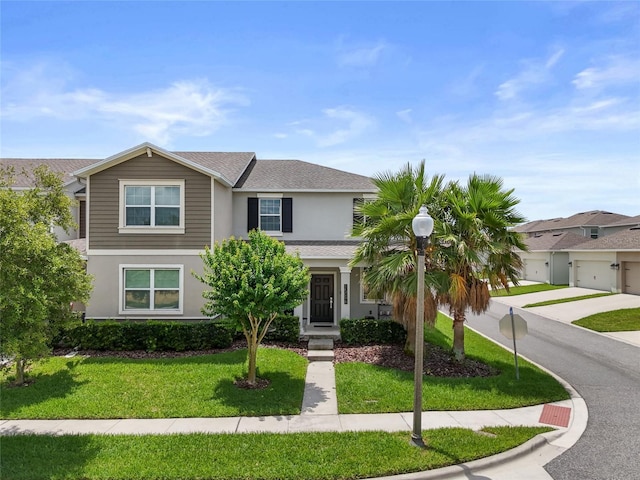 15096 Chapter Way, Winter Garden, FL 34787 - view of front of property featuring stucco siding, a front lawn, concrete driveway, roof with shingles, and a garage