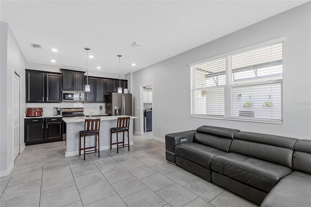 15096 Chapter Way, Winter Garden, FL 34787 - living room featuring light tile patterned floors, healthy amount of natural light, recessed lighting, and baseboards
