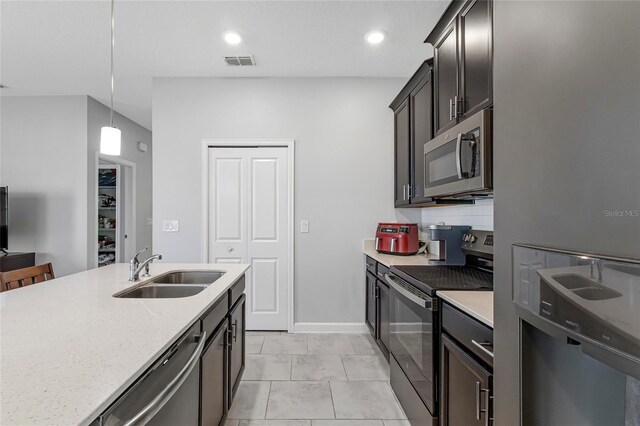 15096 Chapter Way, Winter Garden, FL 34787 - kitchen featuring stainless steel appliances, a sink, pendant lighting, light stone counters, and baseboards
