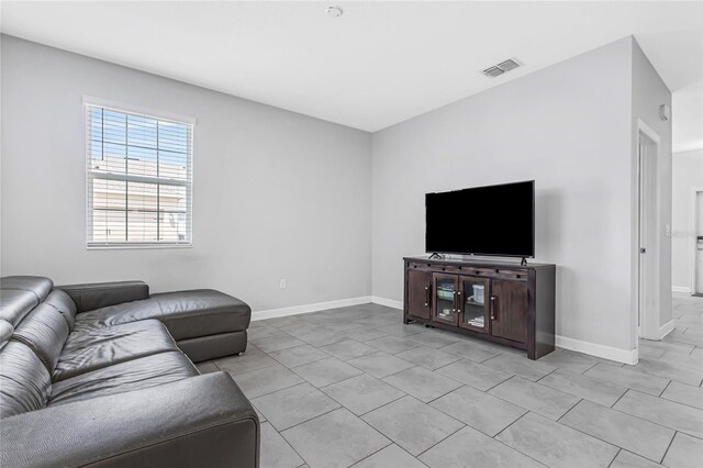 15096 Chapter Way, Winter Garden, FL 34787 - living area featuring baseboards and light tile patterned floors