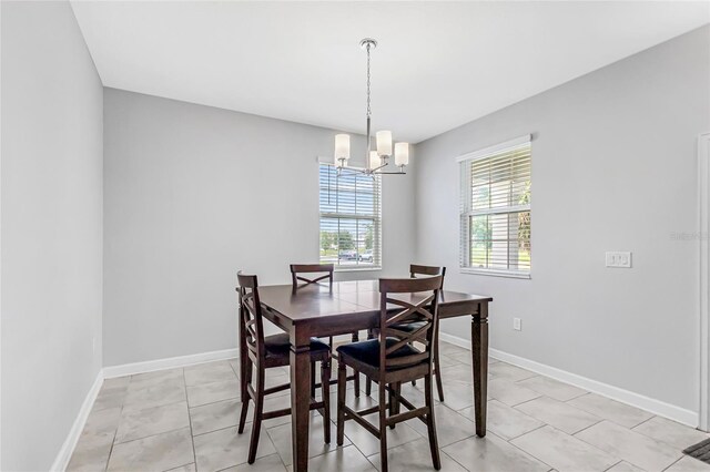 15096 Chapter Way, Winter Garden, FL 34787 - dining space featuring a chandelier, baseboards, and light tile patterned floors