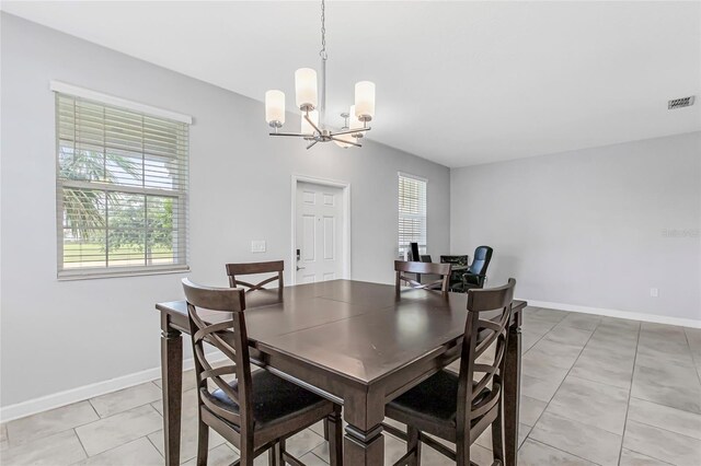 15096 Chapter Way, Winter Garden, FL 34787 - dining area with a chandelier, plenty of natural light, baseboards, and light tile patterned flooring