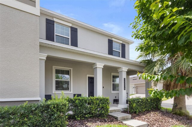 15096 Chapter Way, Winter Garden, FL 34787 - view of front of house with covered porch and stucco siding