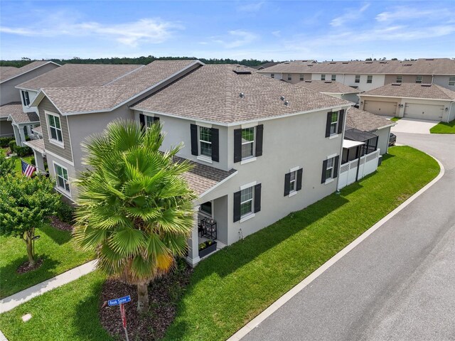15096 Chapter Way, Winter Garden, FL 34787 - view of home's exterior featuring a shingled roof, stucco siding, a lawn, a residential view, and driveway