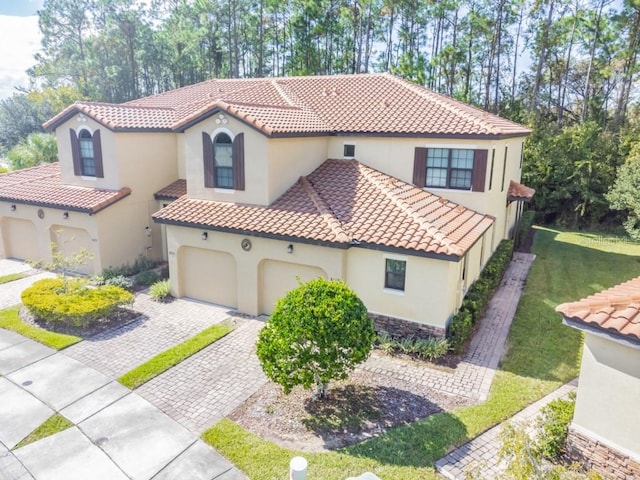 8219 Roseville Blvd, Davenport, FL 33896 - mediterranean / spanish home featuring stucco siding, a tiled roof, and driveway