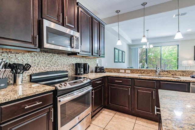 8219 Roseville Blvd, Davenport, FL 33896 - kitchen featuring stainless steel appliances, a sink, dark brown cabinets, decorative backsplash, and light tile patterned floors