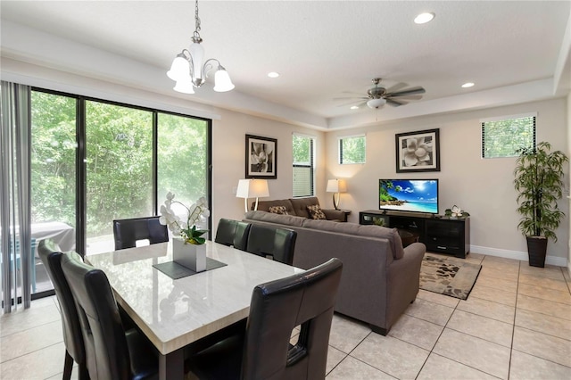 8219 Roseville Blvd, Davenport, FL 33896 - dining space with healthy amount of natural light, a tray ceiling, recessed lighting, and light tile patterned floors