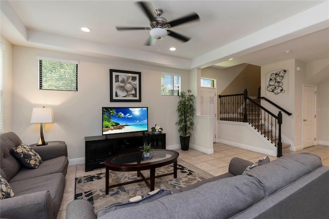 8219 Roseville Blvd, Davenport, FL 33896 - living room with light tile patterned floors, a ceiling fan, a tray ceiling, recessed lighting, and stairs