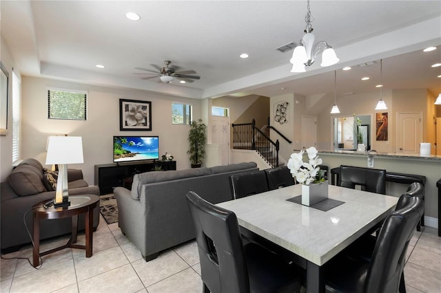 8219 Roseville Blvd, Davenport, FL 33896 - dining room with stairway, light tile patterned floors, recessed lighting, ceiling fan, and a tray ceiling