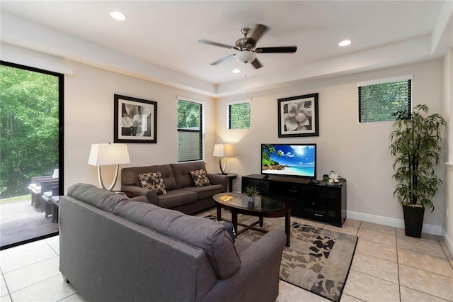 8219 Roseville Blvd, Davenport, FL 33896 - living room featuring ceiling fan, a raised ceiling, light tile patterned floors, healthy amount of natural light, and recessed lighting