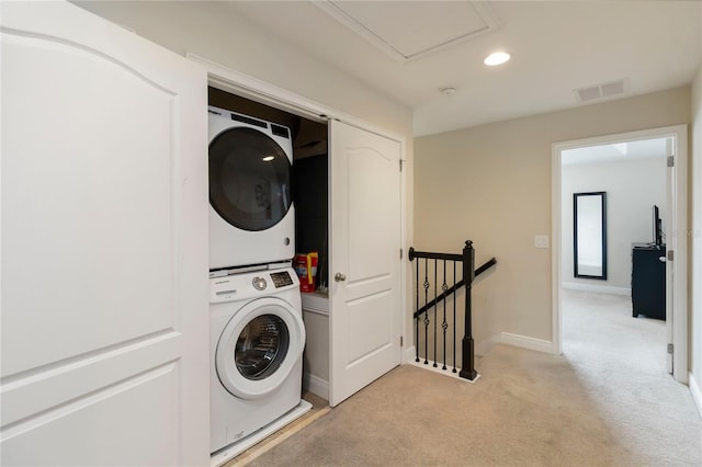 8219 Roseville Blvd, Davenport, FL 33896 - laundry area featuring estacked washer and dryer, light carpet, baseboards, and recessed lighting
