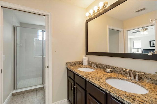 8219 Roseville Blvd, Davenport, FL 33896 - bathroom featuring baseboards, a stall shower, double vanity, tile patterned floors, and ceiling fan