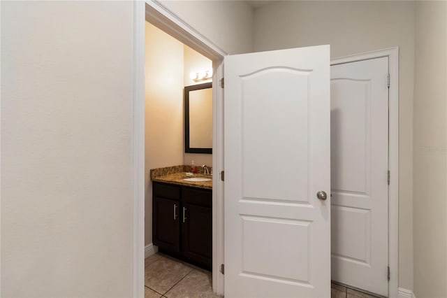 8219 Roseville Blvd, Davenport, FL 33896 - bathroom featuring vanity, tile patterned flooring, and baseboards
