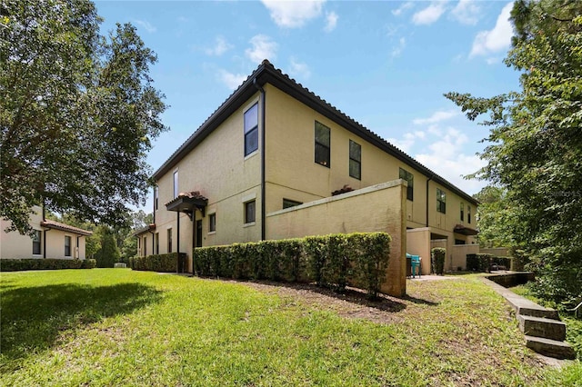 8219 Roseville Blvd, Davenport, FL 33896 - view of property exterior featuring a yard and stucco siding