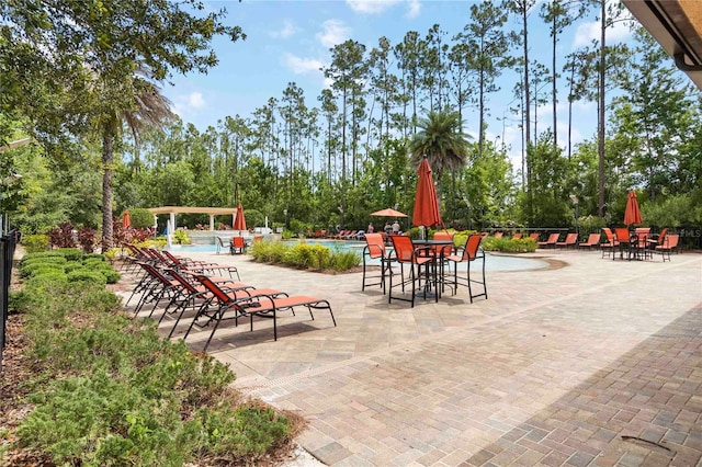 8219 Roseville Blvd, Davenport, FL 33896 - view of patio / terrace featuring a community pool and view of scattered trees