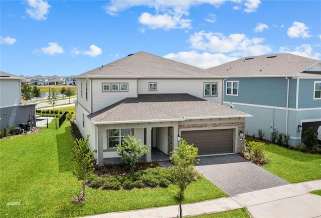 13323 Panama Beach Ct, Orlando, FL 32827 - view of front of home with a shingled roof, a garage, decorative driveway, and a front lawn