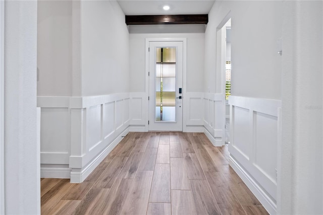 13323 Panama Beach Ct, Orlando, FL 32827 - entryway with wainscoting, wood finished floors, a decorative wall, and beamed ceiling