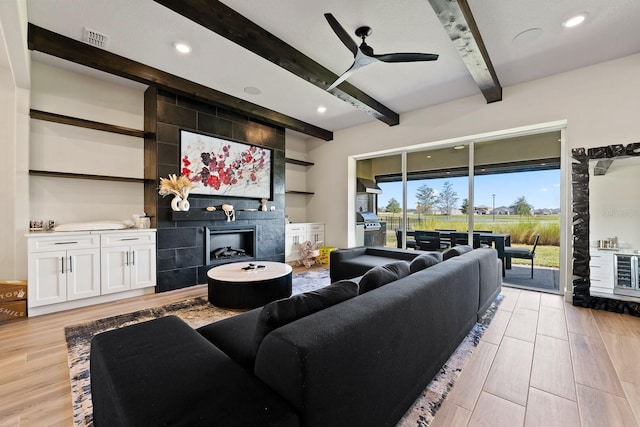 13323 Panama Beach Ct, Orlando, FL 32827 - living area featuring beam ceiling, a tile fireplace, light wood-style flooring, a ceiling fan, and recessed lighting
