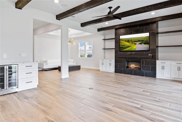 13323 Panama Beach Ct, Orlando, FL 32827 - unfurnished living room with wine cooler, light wood-style flooring, beam ceiling, a ceiling fan, and baseboards