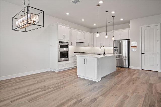 13323 Panama Beach Ct, Orlando, FL 32827 - kitchen featuring stainless steel appliances, a sink, light countertops, backsplash, and light wood finished floors