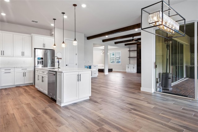 13323 Panama Beach Ct, Orlando, FL 32827 - kitchen featuring appliances with stainless steel finishes, open floor plan, light countertops, light wood-style flooring, and recessed lighting