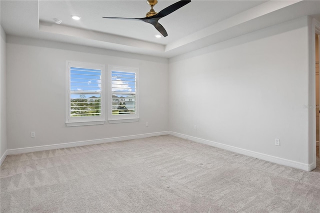 13323 Panama Beach Ct, Orlando, FL 32827 - empty room featuring a raised ceiling, light colored carpet, ceiling fan, baseboards, and recessed lighting