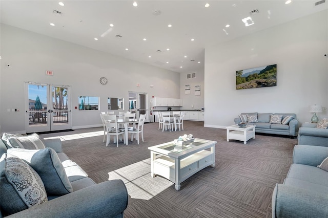 13323 Panama Beach Ct, Orlando, FL 32827 - carpeted living area featuring a towering ceiling, recessed lighting, baseboards, and french doors
