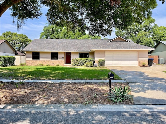 5724 Pitch Pine Dr, Orlando, FL 32819 - ranch-style house with brick siding, an attached garage, driveway, and roof with shingles