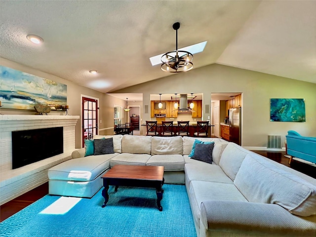 5724 Pitch Pine Dr, Orlando, FL 32819 - living room with a skylight, lofted ceiling, a brick fireplace, and dark wood-style floors