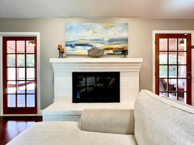 5724 Pitch Pine Dr, Orlando, FL 32819 - detailed view of a fireplace, wood finished floors, and a textured ceiling