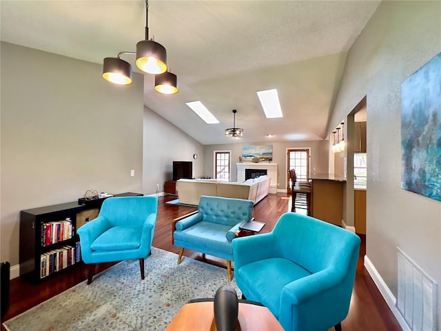 5724 Pitch Pine Dr, Orlando, FL 32819 - living room with a skylight, vaulted ceiling, wood finished floors, and a fireplace