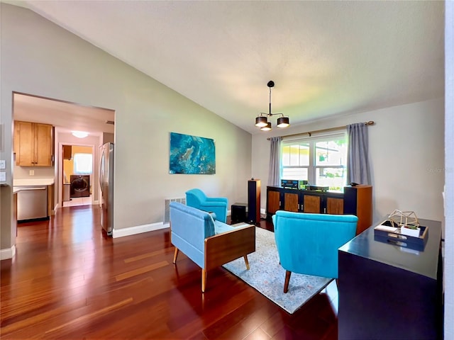 5724 Pitch Pine Dr, Orlando, FL 32819 - living room featuring lofted ceiling, dark wood-style floors, a chandelier, and washer / dryer