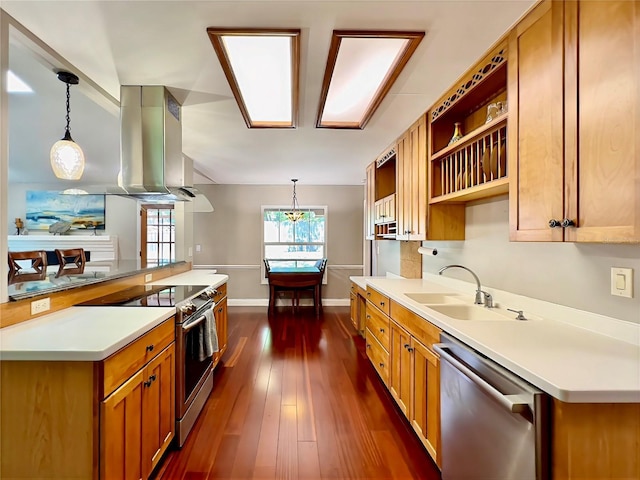 5724 Pitch Pine Dr, Orlando, FL 32819 - kitchen with stainless steel appliances, brown cabinetry, decorative light fixtures, light countertops, and dark wood-type flooring