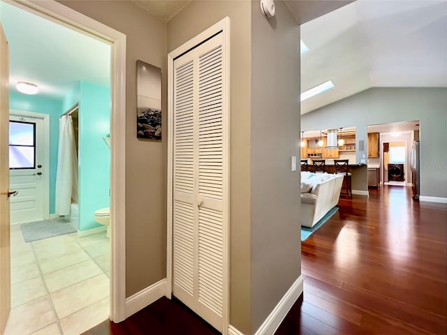 5724 Pitch Pine Dr, Orlando, FL 32819 - hallway with vaulted ceiling and wood finished floors