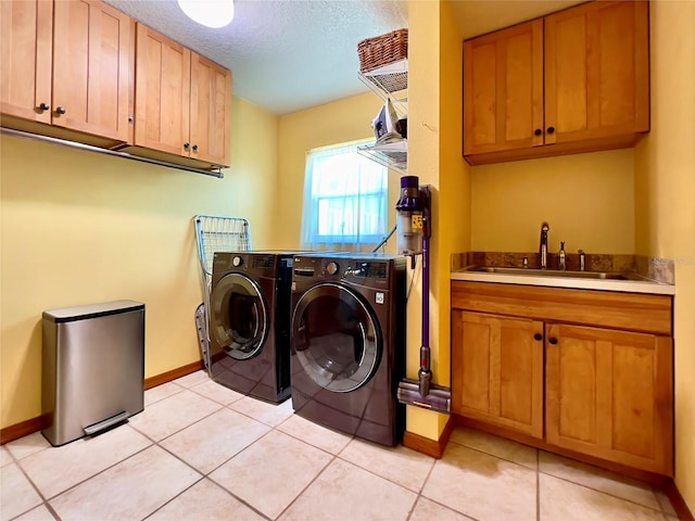 5724 Pitch Pine Dr, Orlando, FL 32819 - laundry room featuring cabinet space, separate washer and dryer, a textured ceiling, and light tile patterned floors