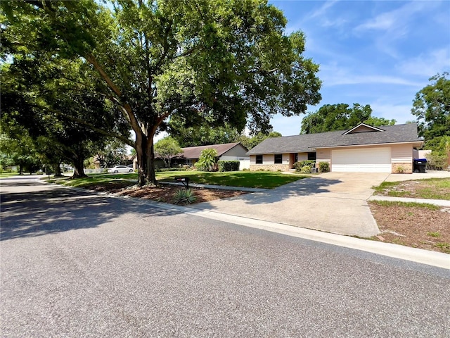 5724 Pitch Pine Dr, Orlando, FL 32819 - ranch-style house with driveway, an attached garage, and a front yard
