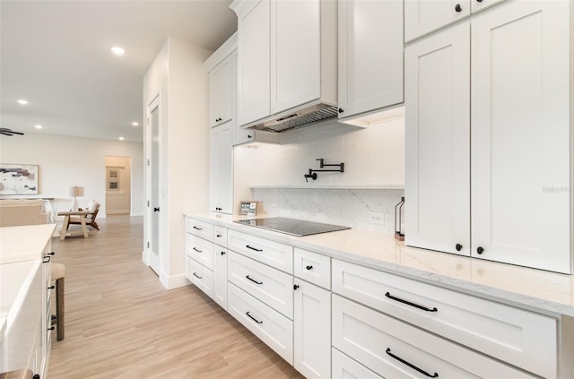 508 Topsail Dr, Rockledge, FL 32955 - kitchen featuring black electric cooktop, decorative backsplash, white cabinets, recessed lighting, and light wood finished floors