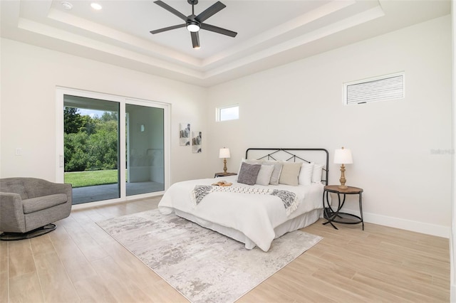 508 Topsail Dr, Rockledge, FL 32955 - bedroom with a raised ceiling, access to outside, light wood-type flooring, recessed lighting, and ceiling fan