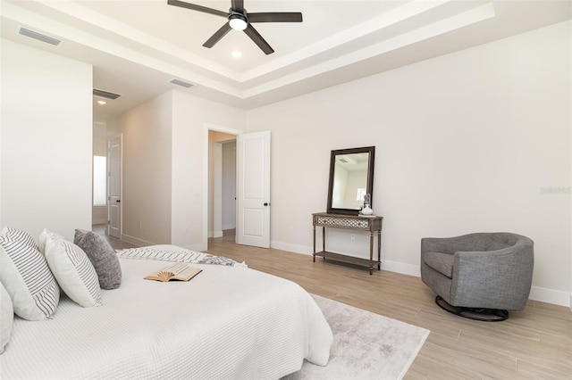 508 Topsail Dr, Rockledge, FL 32955 - bedroom featuring a tray ceiling, light wood-style flooring, and a ceiling fan