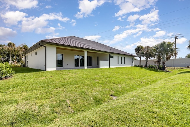 508 Topsail Dr, Rockledge, FL 32955 - back of house featuring a standing seam roof, stucco siding, and a metal roof