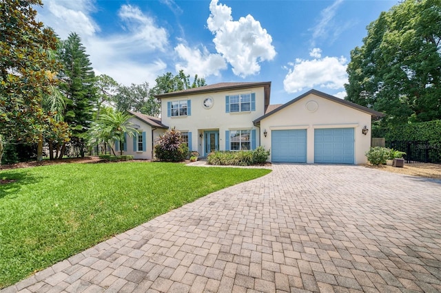 1420 Palmer Ave, Winter Park, FL 32789 - colonial-style house featuring stucco siding, decorative driveway, a garage, and a front lawn