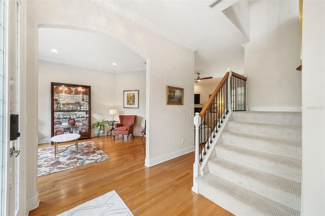 1420 Palmer Ave, Winter Park, FL 32789 - entryway with arched walkways, ceiling fan, stairway, light wood finished floors, and baseboards