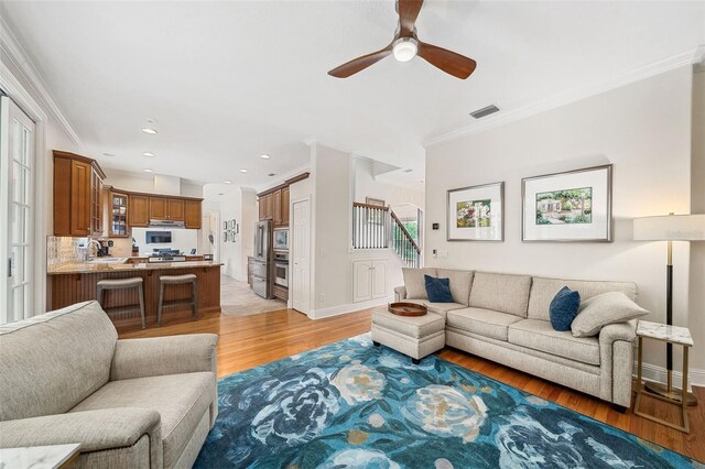 1420 Palmer Ave, Winter Park, FL 32789 - living room with crown molding, ceiling fan, light wood finished floors, stairs, and recessed lighting