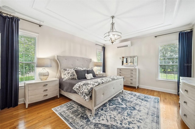 1420 Palmer Ave, Winter Park, FL 32789 - bedroom with a wall mounted air conditioner, light wood finished floors, a chandelier, ornamental molding, and baseboards
