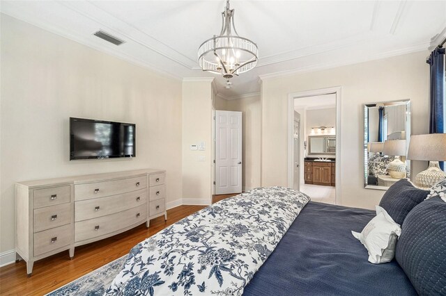1420 Palmer Ave, Winter Park, FL 32789 - bedroom with a chandelier, wood finished floors, ornamental molding, baseboards, and ensuite bathroom