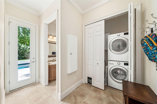 1420 Palmer Ave, Winter Park, FL 32789 - laundry area with stacked washer / dryer, crown molding, light tile patterned flooring, and baseboards